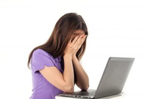 Girl having emotional meltdown at computer