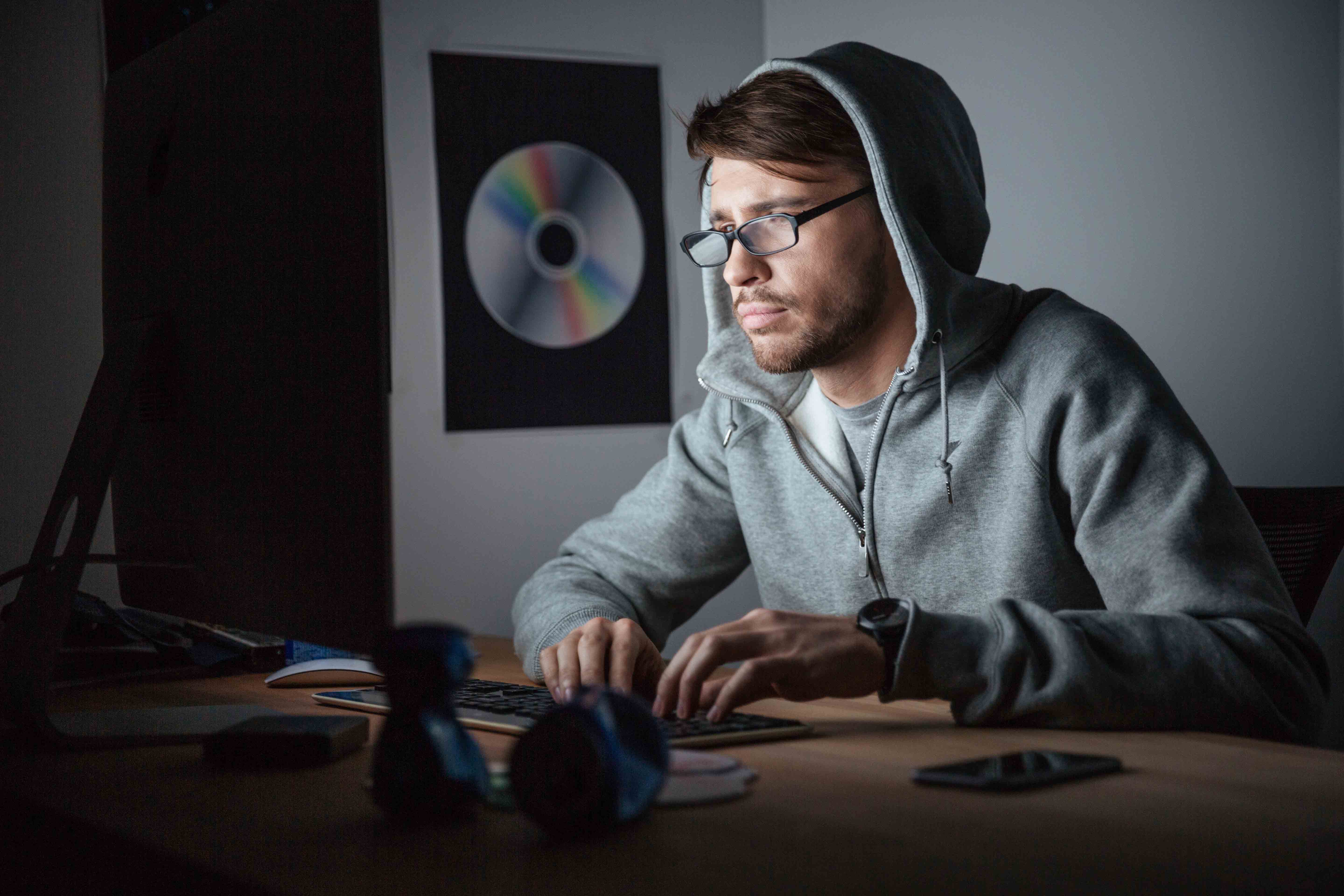 man working late at his computer for is it easy to learn javascript